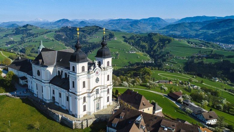 Luftaufnahme der Basilika Sonntagberg in einer grünen Hügellandschaft.